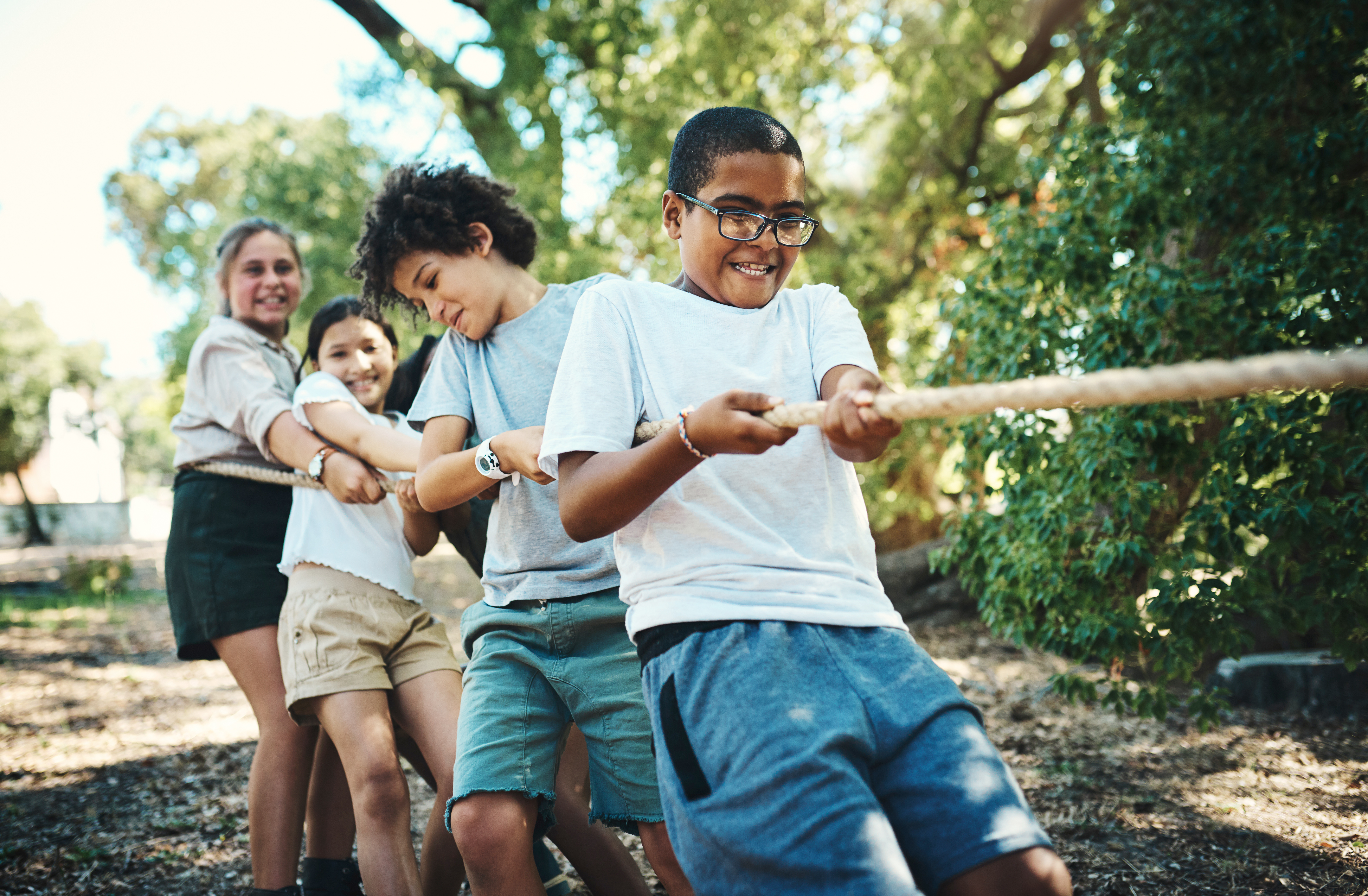 four kids playing tug of war