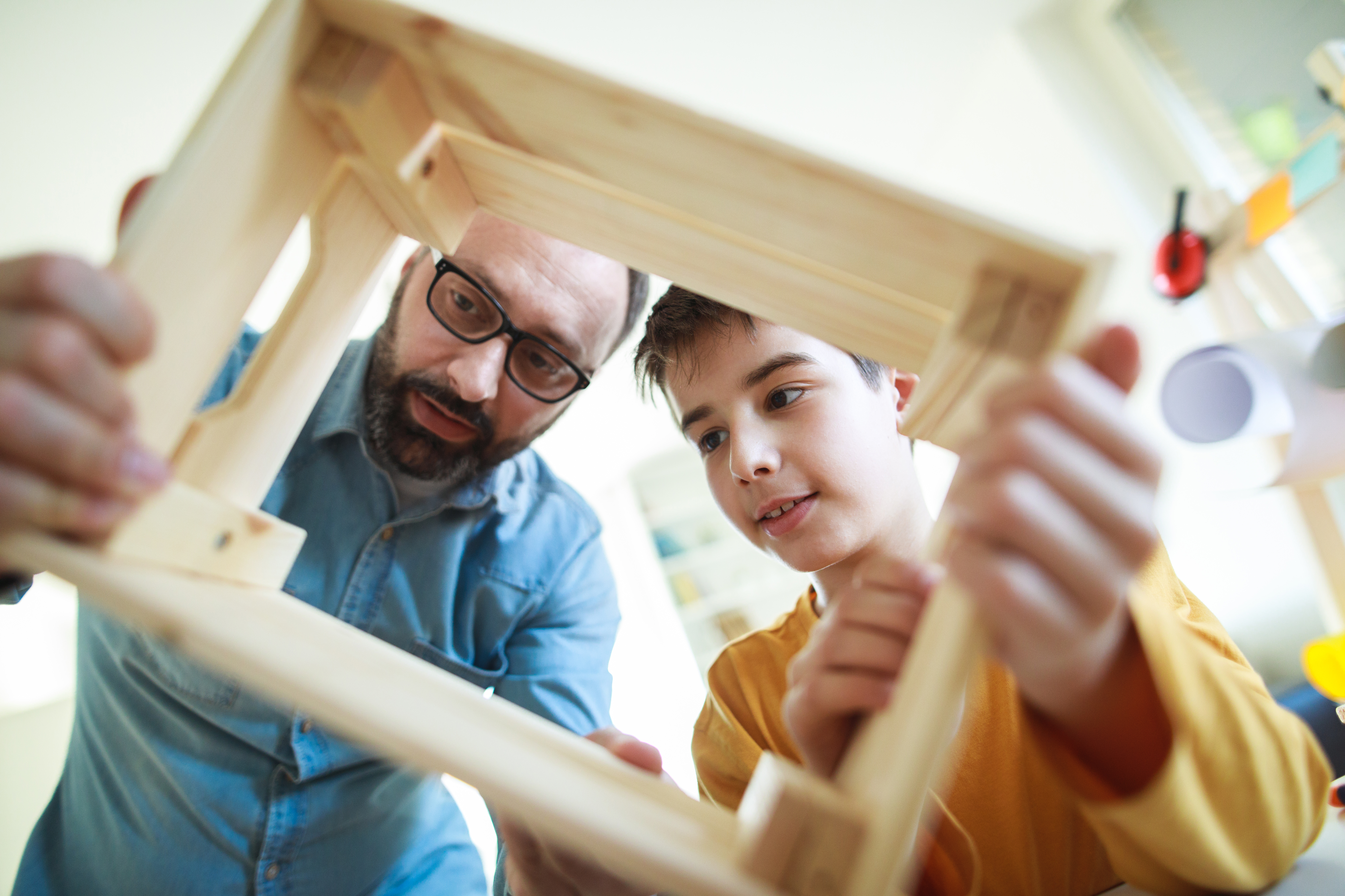 father and son doing arts and craft